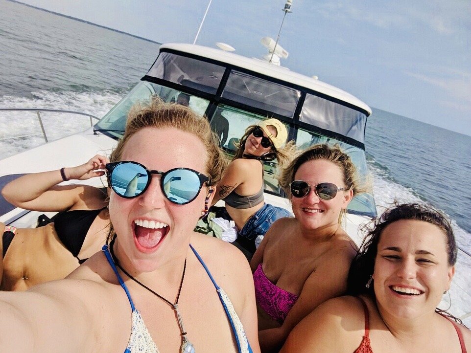 women participate in birthday party on yacht